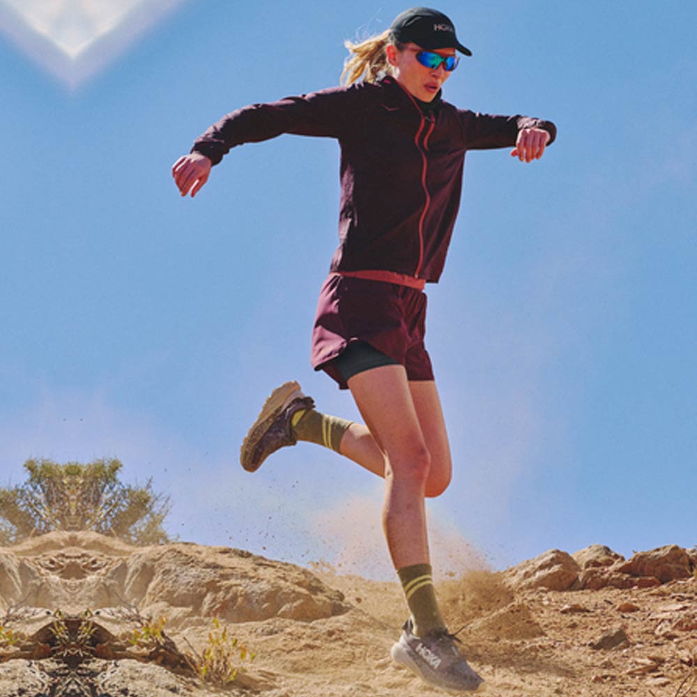 woman running with trail running shoes