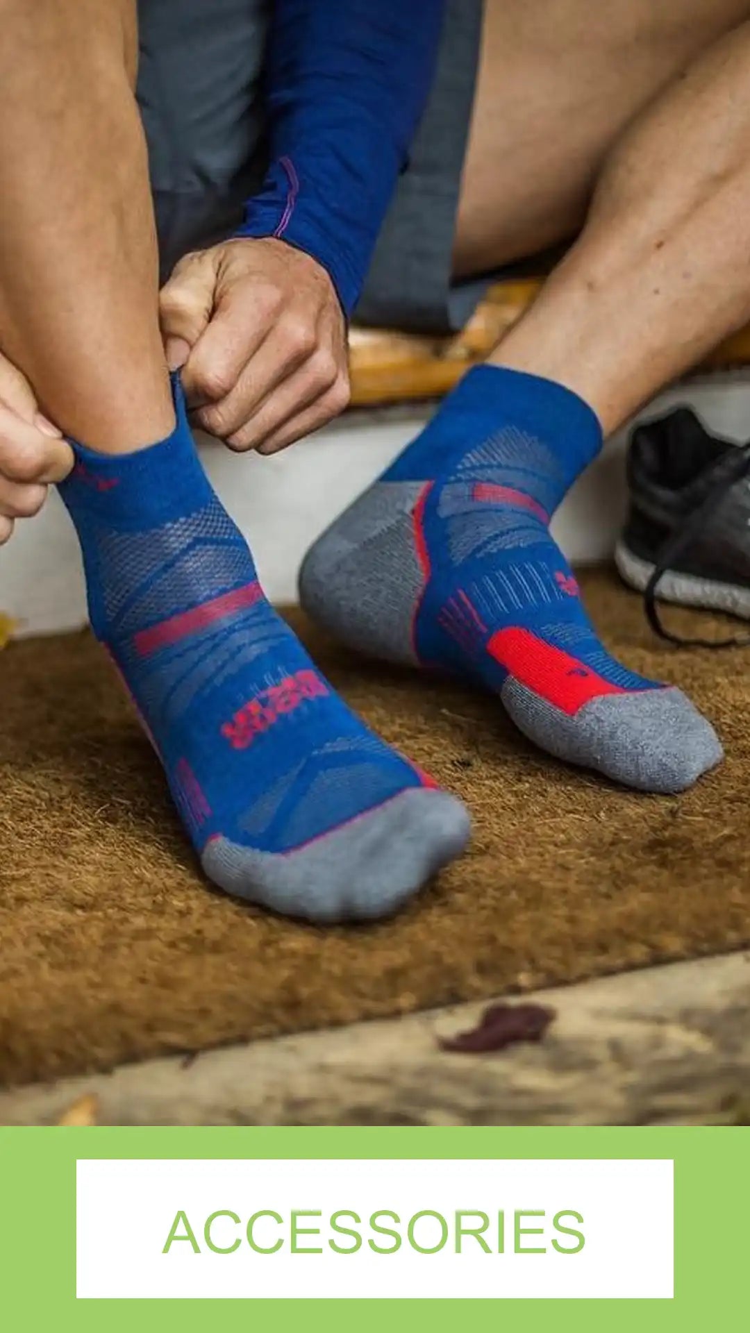 Person wearing blue and gray socks with red accents on a wooden floor.
